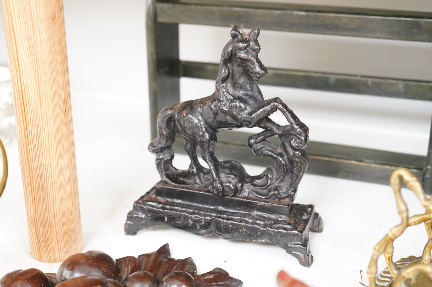 Sundry items to include an iron money box, brass letter rack, horse door stop and a 19th century oak carving, largest 32cm high